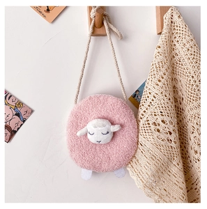 Close-up of pink plush lamb bag showing soft faux fur texture on a wooden hook