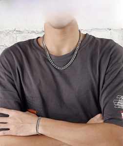 Detailed view of heavy stainless steel Cuban link necklace and bracelet set for men