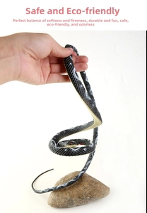 Detailed close-up of a flexible black toy snake with realistic scales and red eyes