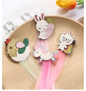 Detailed view of cartoon animal hair clips with colorful synthetic hair extensions