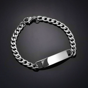 Macro detail of silver stainless steel Cuban link bracelet with a blank rectangular bar