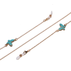 Chaîne de lunettes dorée avec papillons turquoise et boucles en silicone antidérapantes