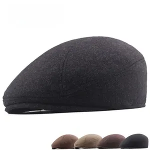Detail shot of herringbone tweed flat cap showing thick texture and various color options