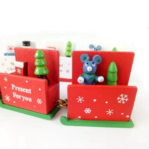 Close-up of wooden Christmas train featuring a mini tree, mouse and snowflake details