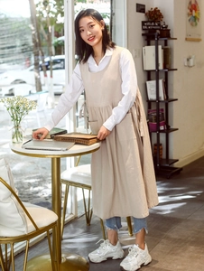 Detailed full view of plus size cotton apron dress in light beige on a model