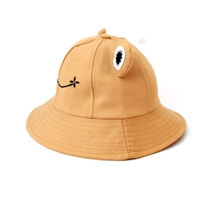 Detailed macro view of khaki cotton canvas frog bucket hat with cute 3D eyes for kids