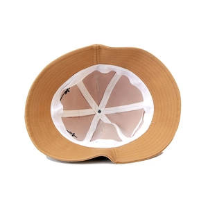 Detail of camel bucket hat interior showing white sweatband and floral embroidery