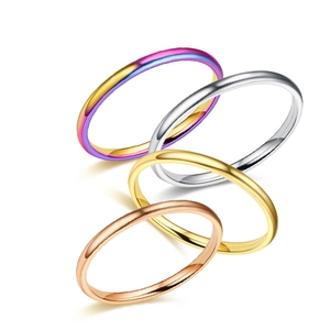 Detailed view of stackable minimalist titanium steel rings in four metallic finishes