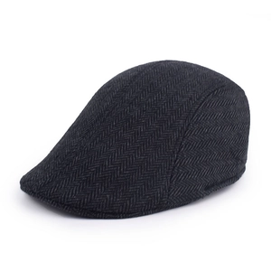 Classic dark grey herringbone flat cap with vintage British wool texture in a retro style
