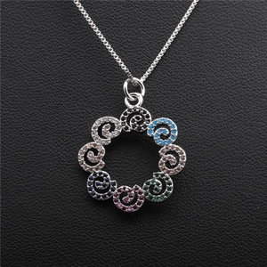 Silver geometric necklace with circular wreath pendant featuring multi-colored zircons