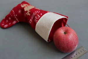 Felt Christmas stocking with My First Christmas embroidery and a ruler for size scale