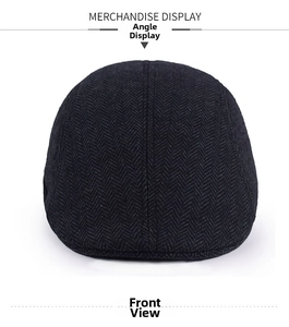 Front view of dark grey herringbone wool newsboy cap showing detailed woven fabric texture