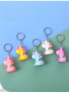 Detailed view of colorful PVC unicorn keychains in five pastel shades with metal rings