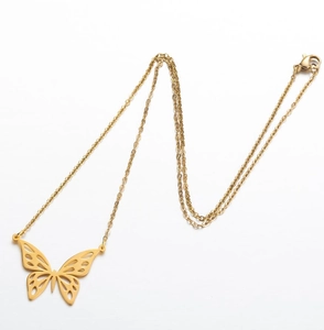 Detail shot of a delicate golden butterfly pendant necklace with a polished finish