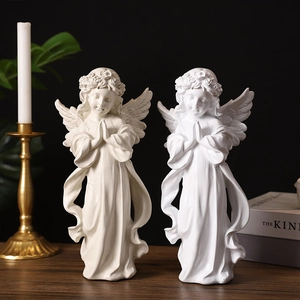 Nordic praying angel sculptures in white and cream with wings and flower crown details