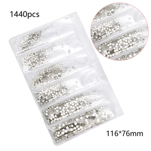 Macro detail of 1440pcs white glass nail rhinestones in 6-grid pack with cut surface