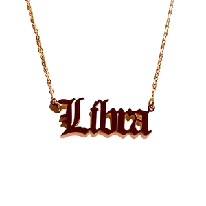 Gothic style Libra zodiac pendant necklace in rose gold finish on white background
