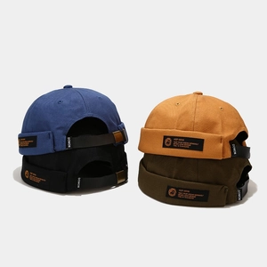 Men's cotton docker cap set in green, yellow, blue, and black with leather strap
