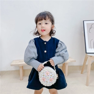 Navy velvet girls' dress with grey puff sleeves and a round floral crossbody bag