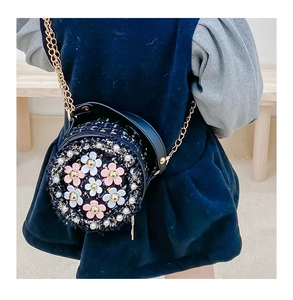 Detail of navy tweed circular crossbody bag with 3D flowers and gold chain strap