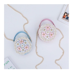 Detail of tweed round mini crossbody bags with 3D flowers, pearls, and gold chain straps