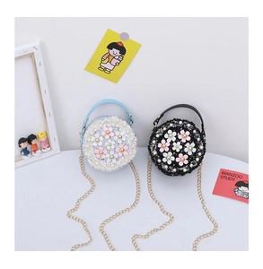 Detail of tweed crossbody bag for girls featuring 3D flowers and faux pearl accents