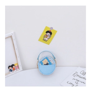Detail of light blue round crossbody bag with 3D flower and gold chain strap for girls