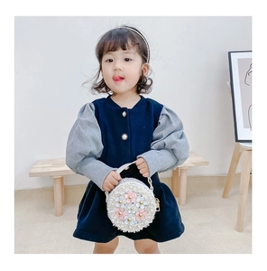 Girl holding mini round crossbody bag with 3D floral decorations and white sequins