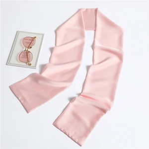 Pink satin narrow scarf for women elegantly displayed with gold glasses and a book