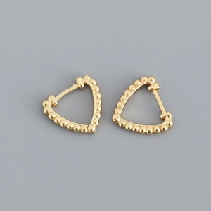 Detailed macro view of S925 sterling silver triangle hoop earrings with gold bead texture