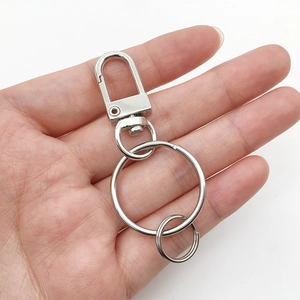 Detail of silver swivel lobster clasp and split rings on white background