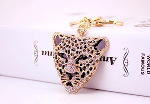 Macro shot of rhinestone-encrusted leopard head keychain with elegant gold-tone metal ring