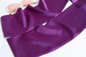Detail of purple satin scarf with smooth silk texture and soft reflective folds