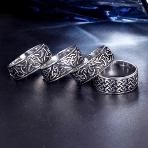 Detail view of four vintage Norse Viking stainless steel rings with Celtic knot patterns