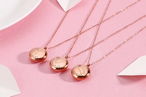 Detail of rose gold zodiac necklaces with Aries Taurus and Gemini constellation charms