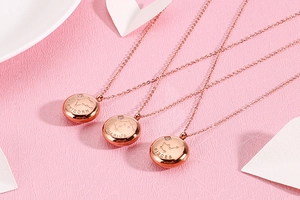 Detailed close-up of rose gold zodiac necklaces for Capricorn, Aquarius, and Pisces signs