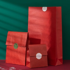 Tre dimensioni di sacchetti regalo festivi rossi con sigilli dorati Happy Winter e texture