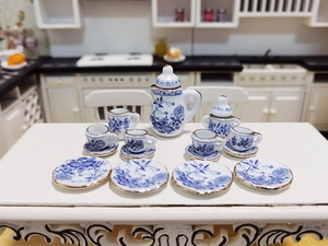 Macro shot of 15-piece miniature ceramic tea set with blue floral patterns for dollhouses