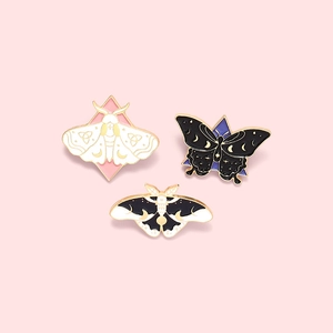 Set of three mystic moth and butterfly enamel pins with crescent moon and star patterns