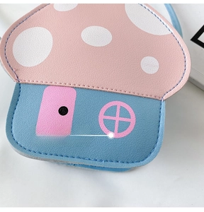 Close-up of pink and blue mushroom-shaped kids bag with textured faux leather detail