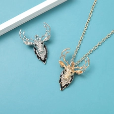 Detailed view of elk jewelry set with rhinestones on a brooch and pendant necklace