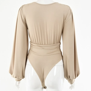 Back view of beige long sleeve bodysuit featuring a deep V-neck and lantern sleeves