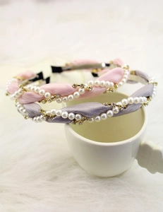 Close-up of twisted fabric headbands with elegant pearls and sparkling rhinestones