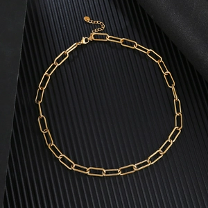 Detail of golden paperclip chain necklace with lobster clasp and extension link
