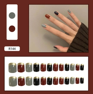 French tip press-on nails set in red, grey, and black with elegant gold edge details