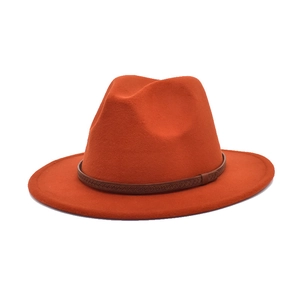 Classic bright orange wool felt fedora hat with brown leather band for winter travel