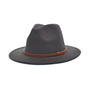 Detail of a dark gray wool fedora hat with a brown patterned leather belt accessory