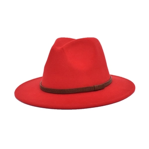 Detail of red wool felt jazz fedora featuring a stylish brown patterned decorative band