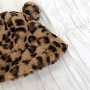 Close-up of leopard print faux fur bucket hat with cute animal ears and plush texture