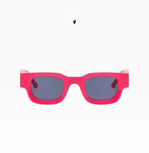 Macro detail of rectangle sunglasses with bright rose red frames and dark smoke lenses